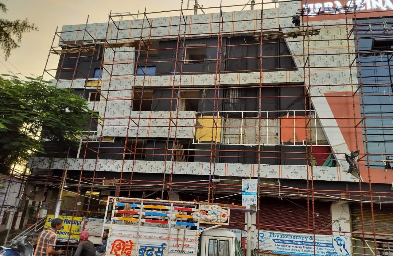 Facade scaffolding on a commercial building in Indore during ACP panel fixing