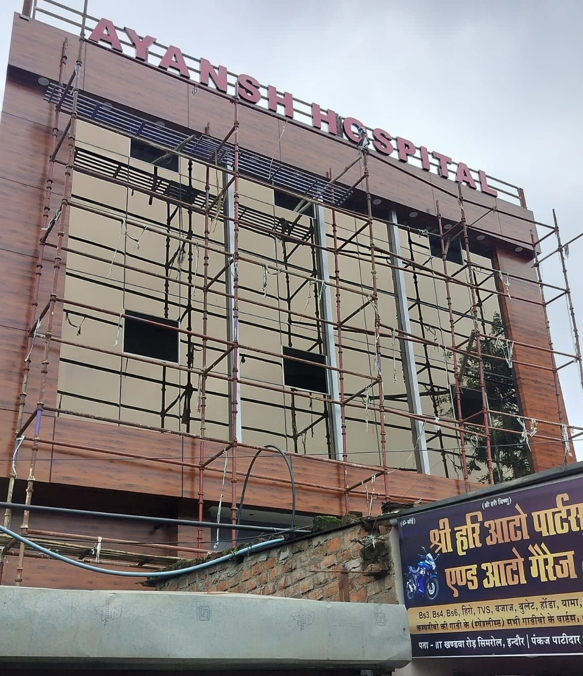 Scaffolding across a hospital front elevation during ACP cladding installation